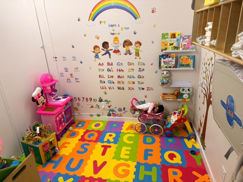 Cozy playroom with books, toys and soft cushions
